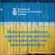 This image shows a blue and yellow container with text indicating ϲֱֳ American University London's continued support for partners in Ukraine after two years.